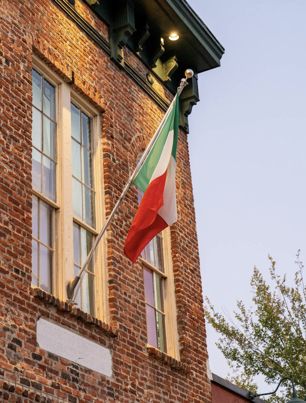 Italian flag hanging from a historic brick building in Columbia, SC